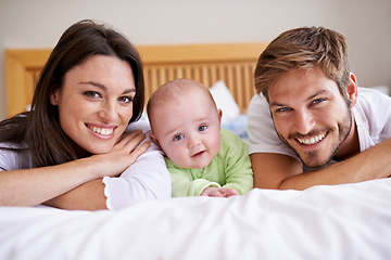 Image showing Happy portrait of mother, father and baby on bed for love, care and fun quality time together at home. Parents, cute newborn child and family bonding to relax in bedroom for support, happiness or joy