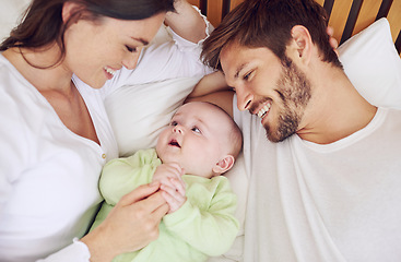 Image showing Top view of happy family, parents and baby in bedroom for love, care and quality time together at home. Mother, father and newborn kid relax on bed with support, childhood development and happiness