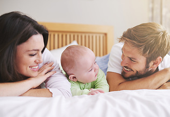 Image showing Mother, father and baby relax on bed for love, care and fun quality time together at home. Happy family, parents and newborn bonding in bedroom for support, happiness or nurture childhood development