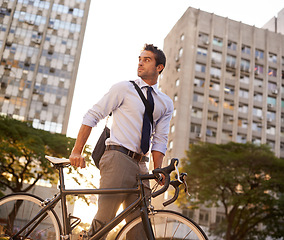 Image showing Cycling, commute and business man in city for morning, carbon neutral and transportation. Sustainable, professional and travel with male employee walking with bike in urban town for journey and trip