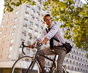 Image showing Cycling, bicycle and business man in city for commute, carbon neutral and transportation. Sustainable, professional and travel with male employee riding on bike in urban town for journey and trip