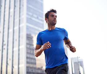 Image showing Fitness, city and male athlete running for health, wellness or training for a marathon, competition or race. Sports, runner and man doing outdoor cardio exercise for endurance or speed in urban town.