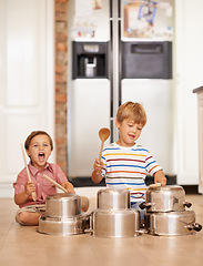 Image showing Rock, pots and drums with children in kitchen for imagination, fantasy and games. Bonding, siblings and happy with kids and kitchenware on floor of family home for music, noise and happiness