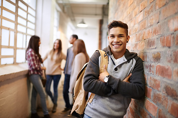 Image showing Education, arms crossed and portrait of man in school hallway for studying, college and scholarship. Future, happy and knowledge with student leaning on brick wall for university, academy and campus