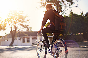 Image showing Travel, bicycle and back of man in road with lens flare for exercise, commute and cycling in morning. Transport, city and male cyclist on bike for eco friendly traveling, carbon footprint and journey