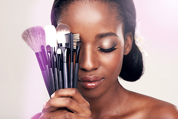 Image showing Beauty, makeup and brushes, black woman in studio with cosmetic application tools and glamour. Skincare, brush and cosmetics, facial skin care glow, model with luxury contour tool on white background