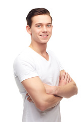 Image showing Fashion, arms crossed and smile with portrait of man in studio for confident, positive and casual. Trendy, happy and face with male model isolated on white background for happiness, natural and cool