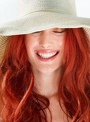 Image showing Happy woman, face and ginger or red hair with straw hat in studio, isolated white background and beautiful style. Female model with happiness and closeup of cool summer accessory, fashion and beauty