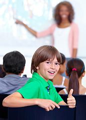 Image showing Thumbs up, teaching and child portrait for happy learning, support and thank you with education success, school or geography. Like, yes and achievement hand or emoji of boy kid with map in classroom