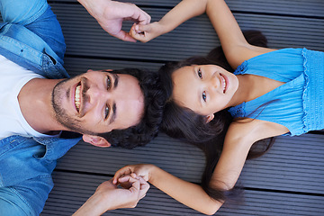 Image showing Holding hands, floor portrait and relax happy family, children and dad smile for Fathers day, outdoor peace and connection. Solidarity, closeup and young kid, girl or youth child bonding with parent