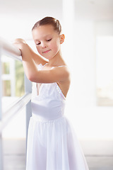 Image showing Young girl, ballerina and ballet class with kid dancer at academy, practice dancing at studio. Female child learning to dance in lesson, creativity with fitness and training, focus and concentration