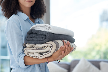 Image showing Clean laundry, holding and hands with towels from the wash for the house and fresh linen. Cleaner, organize and a woman with clothes in an apartment, packing and organizing clothing for routine
