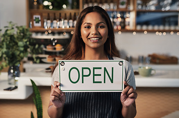 Image showing Happy woman, open sign and portrait at cafe of small business owner or waitress for morning or ready to serve. Female person or restaurant server holding board for coffee shop or cafeteria opening