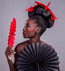 Image showing Culture, makeup and creative with black woman in studio for origami, art and beauty. Traditional, cosmetics and paper design with female model and fans on grey background for asian, retro or color