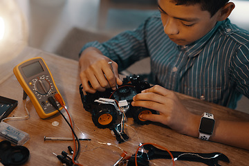 Image showing Education, car robot and top view of child with homework, homeschool and science, learning and tech project. Robotics, building and boy kid with electrical knowledge, engineering or studying in house