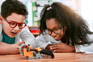 Image showing Engineering, school and kids building a robot hand together in a classroom at school and being curious. Clever, education and young engineer students working in a science class doing research