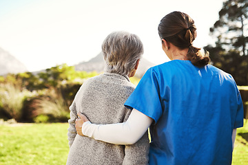 Image showing Senior woman, nurse and hug in healthcare, life insurance or support together in nature. back view of mature female with caregiver in elderly care, medical aid or garden walk at nursing home outdoors