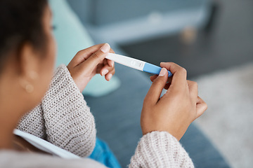 Image showing Pregnancy test, woman hands and waiting at home for results on a living room couch. House, female person and hand with medical and fertility testing stick to show pregnant sign alone on lounge sofa