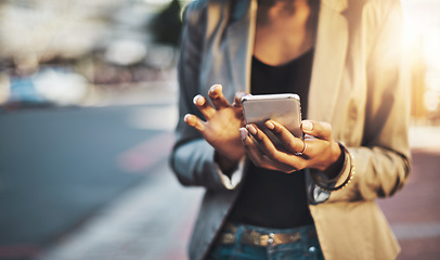 Image showing Business woman, hands and phone in city networking, social media or texting outdoors. Hand of female professional chatting on mobile smartphone for communication or browsing in street of urban town