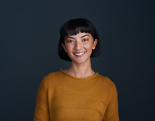 Image showing Woman with smile in portrait, happy and confident with young person isolated on blue background. Youth, gen z and female model in studio with mockup space, positive mindset and happiness