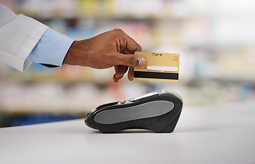 Image showing Man, hand and pharmacist with credit card on machine for payment, purchase or swipe in checkout at pharmacy. Hands of person, medical or healthcare expert paying on pos system at pharmaceutical store