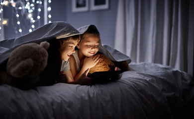 Image showing Night, tablet and siblings in bed, home or watching a movie, film or cartoon with happiness. Children, kids or brother with sister, technology or online games with a smile, dark or relax in a bedroom