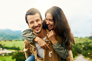 Image showing Happy, love and piggyback with couple in nature for happy, smile and bonding. Happiness, relax and care with portrait of man carrying woman on countryside date for spring, vacation and support