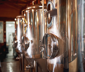 Image showing Big fermentation tanks, beer and factory with industry, container and industrial machine. Brewery, alcohol and manufacturing with steel, metal and system with labor, shine, product and machinery