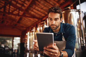 Image showing Tablet, focus and brewery with man in factory for production, manufacturing and alcohol fermentation. Technology, inspection and digital with business owner for distillery, storage or quality control