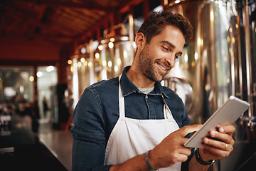 Image showing Tablet, beer and smile with man in factory for production, manufacturing and alcohol fermentation. Technology, inspection and digital with business owner for distillery, storage and quality control