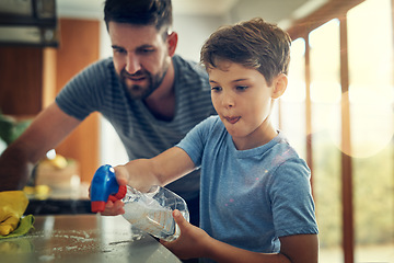 Image showing Family, father and son cleaning the kitchen counter, development and growth at home. Parent, male child and dad with kid, support and teaching with chores, helping and learning with responsibility