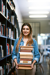 Image showing Woman, college student with stack of books in library and research with studying and learn on university campus. Female person smile in portrait, education and scholarship with reading material