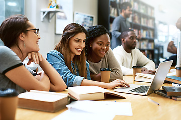 Image showing Women, students in library with laptop and studying for exam or research for project with education. Young female people in study group, search internet on pc and learning on university campus