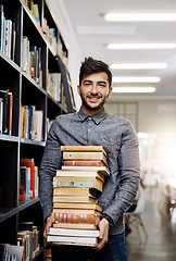 Image showing Man in portrait, college student with stack of books in library and research, studying and learning on university campus. Male person with smile, education and scholarship with reading material