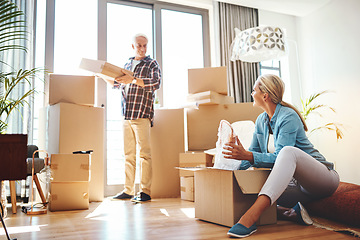 Image showing Real estate, property and a senior couple moving house while packing boxes together in their home. Box, investment and retirement with old people unpacking in the living room of their new apartment