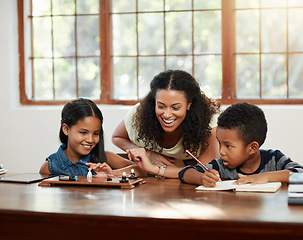 Image showing Education, mother and helping her children with their homework or sitting on table or writing and drawing at home. Teaching, learning and mom with kids doing school task or reading for boy and girl