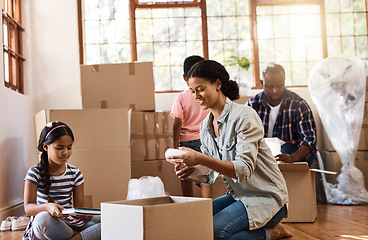 Image showing Boxes, moving and family packing in home living room together with children, mom and dad. Property, real estate investment and house move with couple, kids helping box and cardboard unpacking