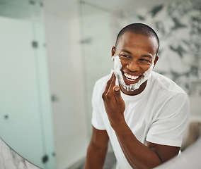 Image showing Black man, foam and happy for shaving, grooming and cosmetics in mirror for self care in home. Young african guy, soap or cream for facial hair, beard and cleaning for hygiene with smile in morning