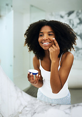 Image showing Skin care, happiness and black woman in bathroom mirror with cream, smile and morning dermatology routine. Health, wellness and luxury skincare at home, girl in reflection and lotion on face for glow