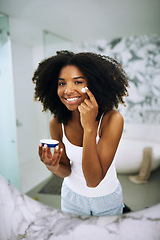 Image showing Skincare, smile and portrait of black woman in bathroom mirror with cream, dermatology and morning routine. Health, wellness and luxury skin care at home, happy girl in reflection with lotion on face