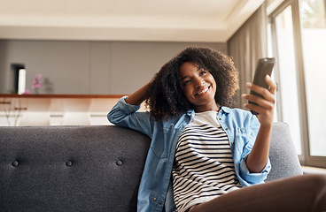 Image showing Relax, black woman with remote and watching tv on sofa in living room of her home. Entertainment or comfort, streaming movie or a series and happy African female person watch television on a couch