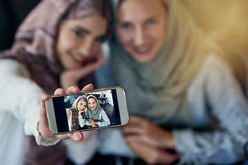 Image showing Muslim women, friends and selfie with cellphone, smile and happiness for post on blog, web or social media. Happy islamic woman, group and smartphone for photography, profile picture or memory on app