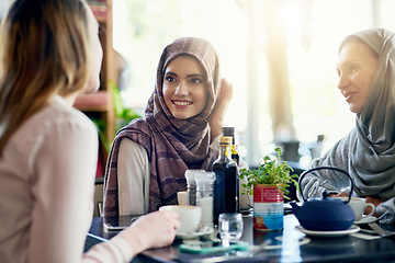 Image showing Muslim women, friends and brunch in restaurant, together and talking with food, smile and discussion. Islamic woman, group and eating lunch with conversation, happy face and listen with food in cafe