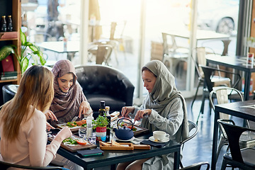 Image showing Muslim women, talking and lunch in restaurant, together or friends with food, smile or happiness. Islamic woman, hungry group and brunch with social conversation, eating or listening to chat in cafe