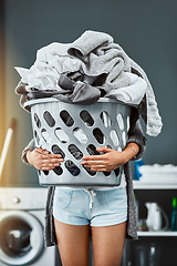 Image showing Laundry, hands and woman with basket in her home for housework, washing and hygiene. House, cleaning and female carrying fresh fabric for spring clean, clothes and household task on the weekend