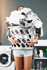 Image showing Laundry, basket and pile of woman with clothes in her home for housework, washing or hygiene. House, cleaning and female carrying fresh fabric for spring clean, tidy and household task on the weekend