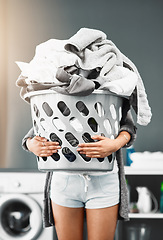 Image showing Laundry basket, pile and woman with clothes in her home for housework, washing and hygiene. House, cleaning and female carrying fresh fabric for spring clean, tidy and household task on the weekend