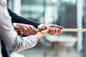 Image showing Hands, teamwork and rope with business people grabbing during a game of tug of war in the office. Collaboration, help or strength with a team of employees or colleagues pulling an opportunity at work