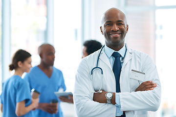 Image showing Man, leader and portrait of doctor in hospital, healthcare or clinic with medical expert nurses to trust in quality care. Black person, medicine and happy neurosurgeon, arms crossed or confidence