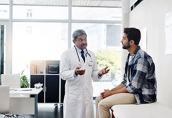 Image showing Healthcare, doctor and patient in consultation with expert advice, information and support in discussion. Medicine, health care and Indian man in doctors office consulting with medical professional.